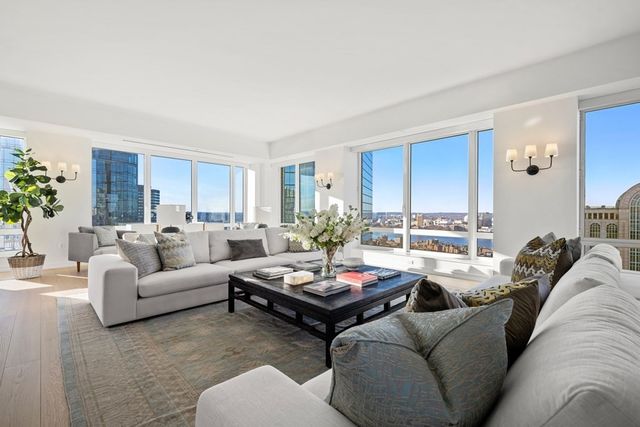 a living room with furniture potted plant and a window