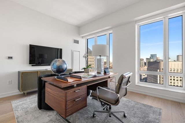 a view of workspace with wooden floor windows