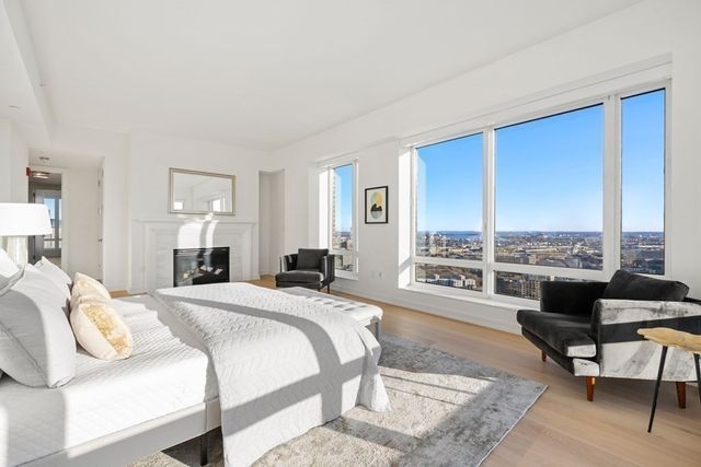 a spacious bedroom with a bed a table and chair