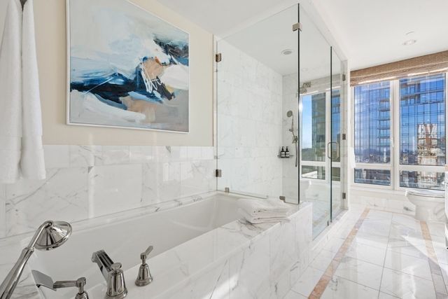 a bathroom with a tub sink and mirror