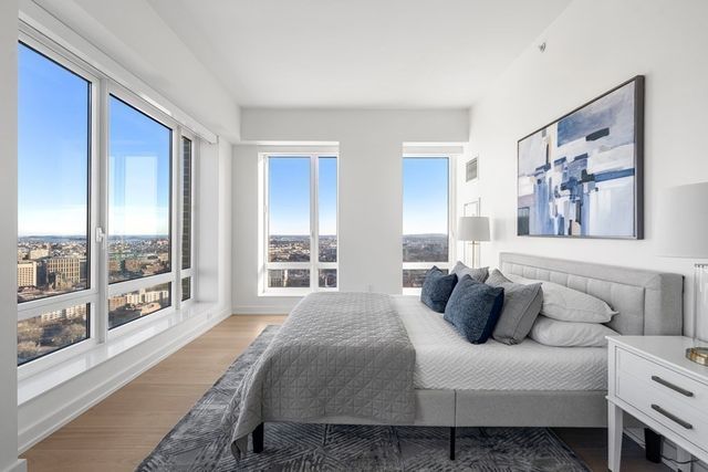 a spacious bedroom with a bed and a large window