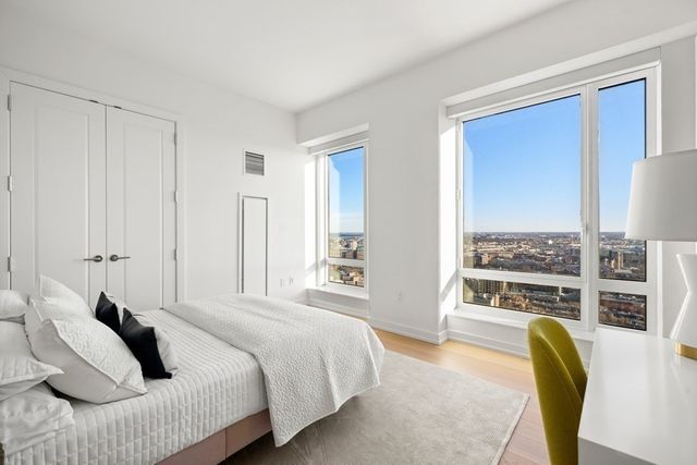a bedroom with a large bed and a balcony