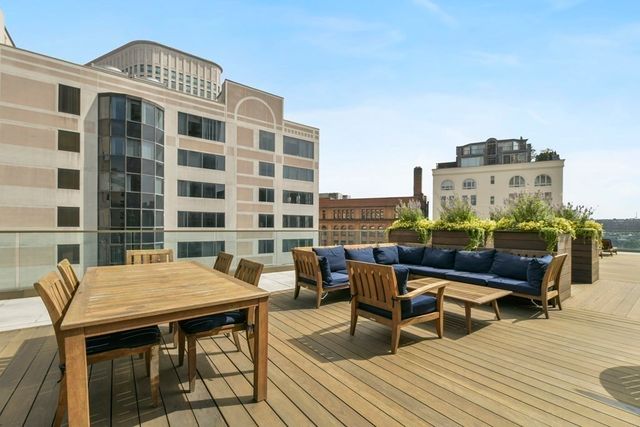 a roof deck with a table and chairs