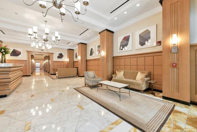 a living room with furniture chandelier and a chandelier