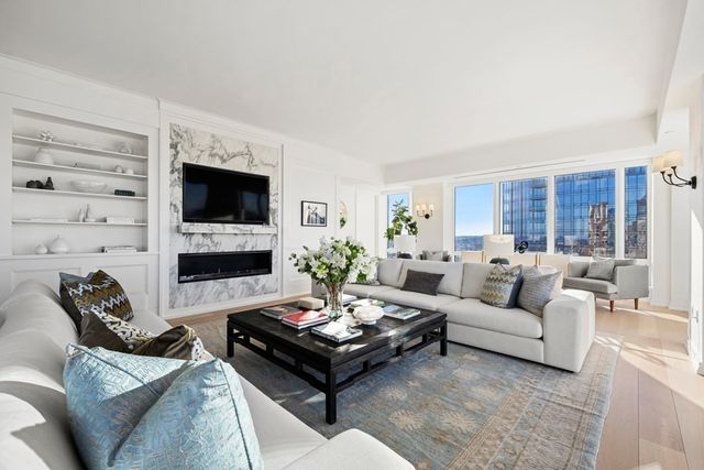 a living room with furniture flat screen tv and a fireplace