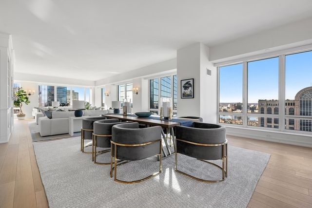 a living room with furniture a rug and white walls