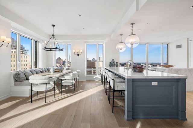 a large kitchen with a table and chairs
