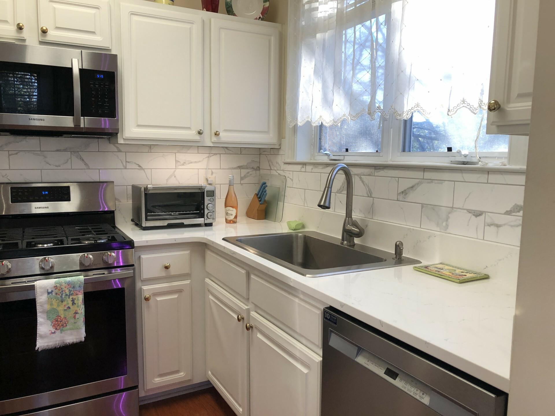 5601 Fairview Road, Unit 26 Charlotte, NC 28209 - Photo 12 of 22 a kitchen with a sink and cabinets