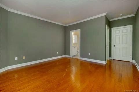 5601 Fairview Road, Unit 26 Charlotte, NC 28209 - Photo 20 of 22 an empty room with wooden floor and windows