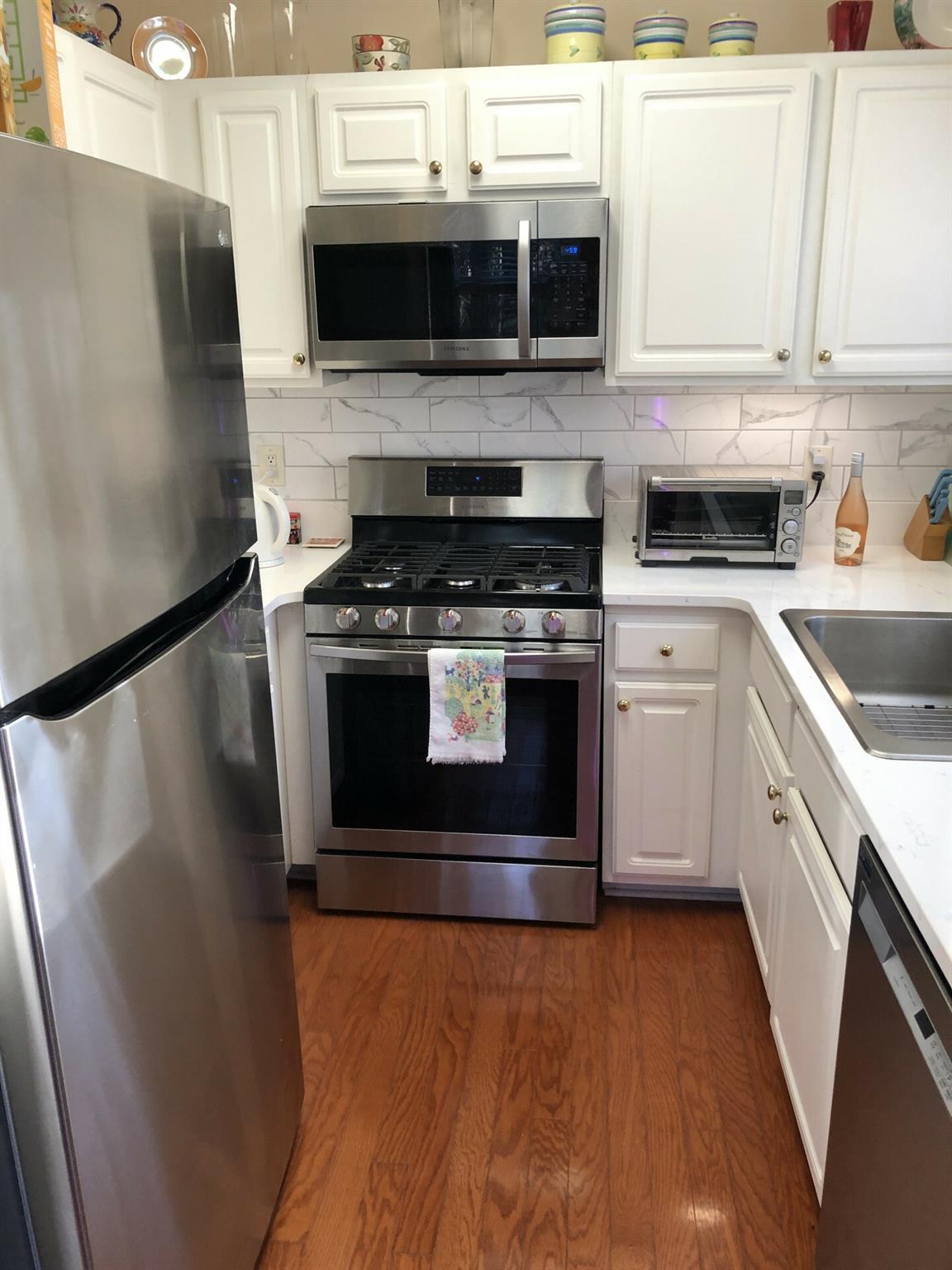 5601 Fairview Road, Unit 26 Charlotte, NC 28209 - Photo 9 of 22 a kitchen with stainless steel appliances a stove a microwave and a refrigerator