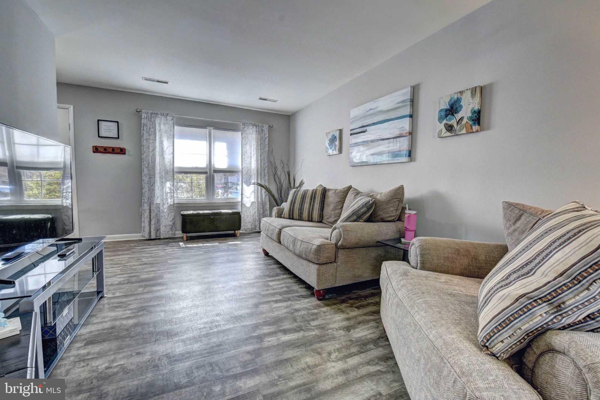 2226 Gunsmith Square Reston, VA 20191 - Photo 4 of 35 a living room with furniture and a flat screen tv
