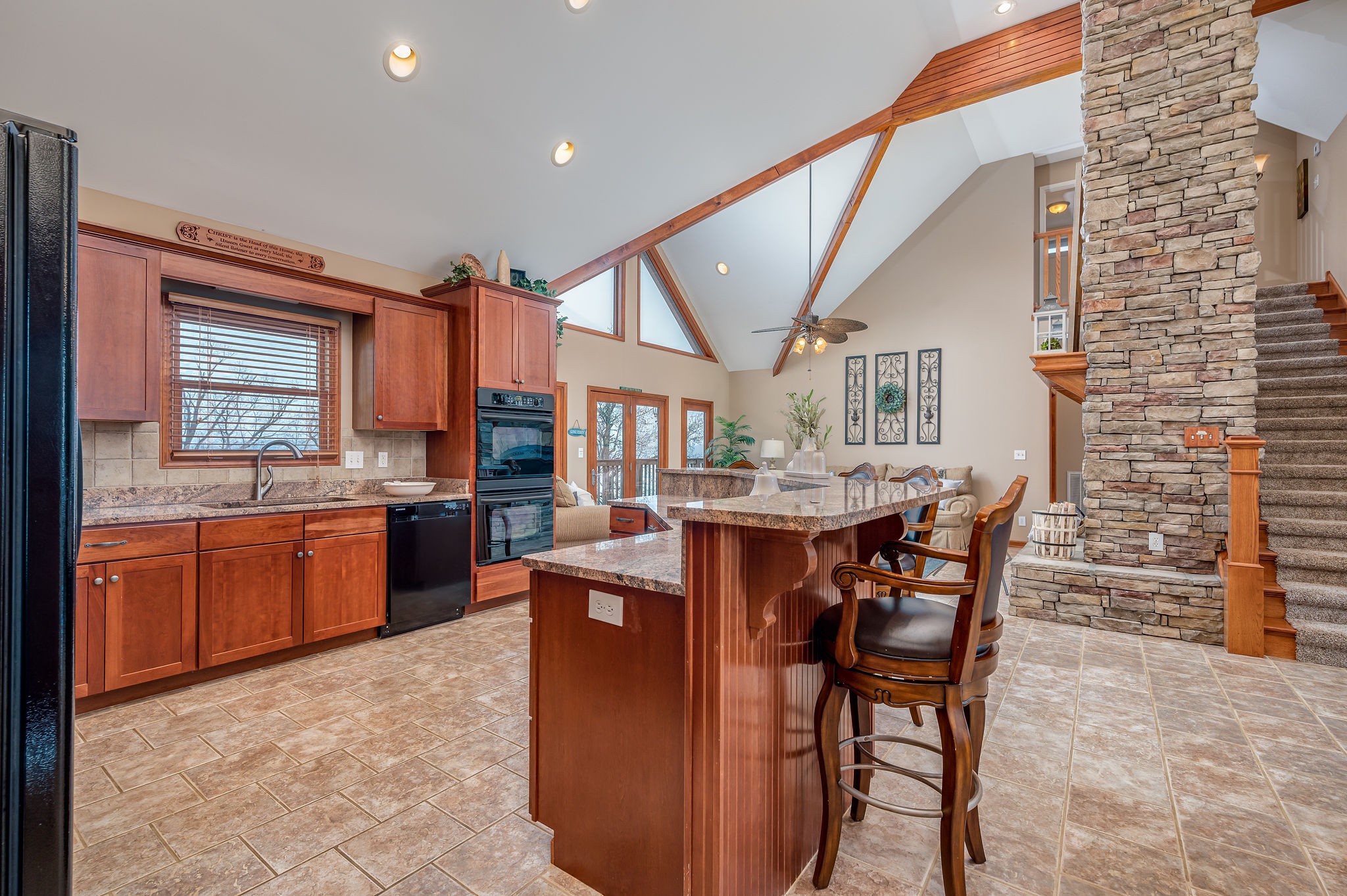 60 Lakeside Estates Road Springville, TN 38256 - Photo 11 of 49 a dining hall with stainless steel appliances kitchen island granite countertop a table chairs and a refrigerator