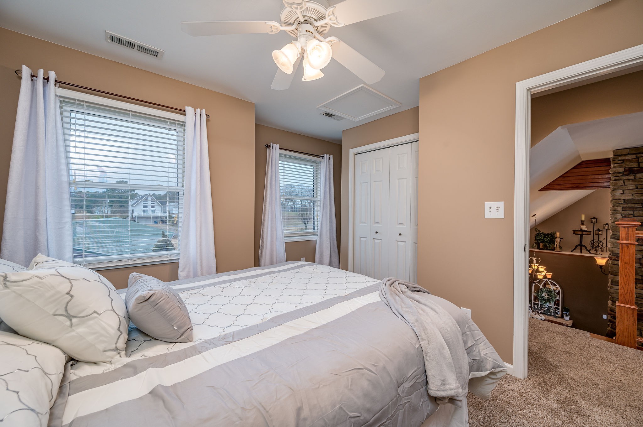 60 Lakeside Estates Road Springville, TN 38256 - Photo 24 of 49 a bedroom with a large bed and a chandelier