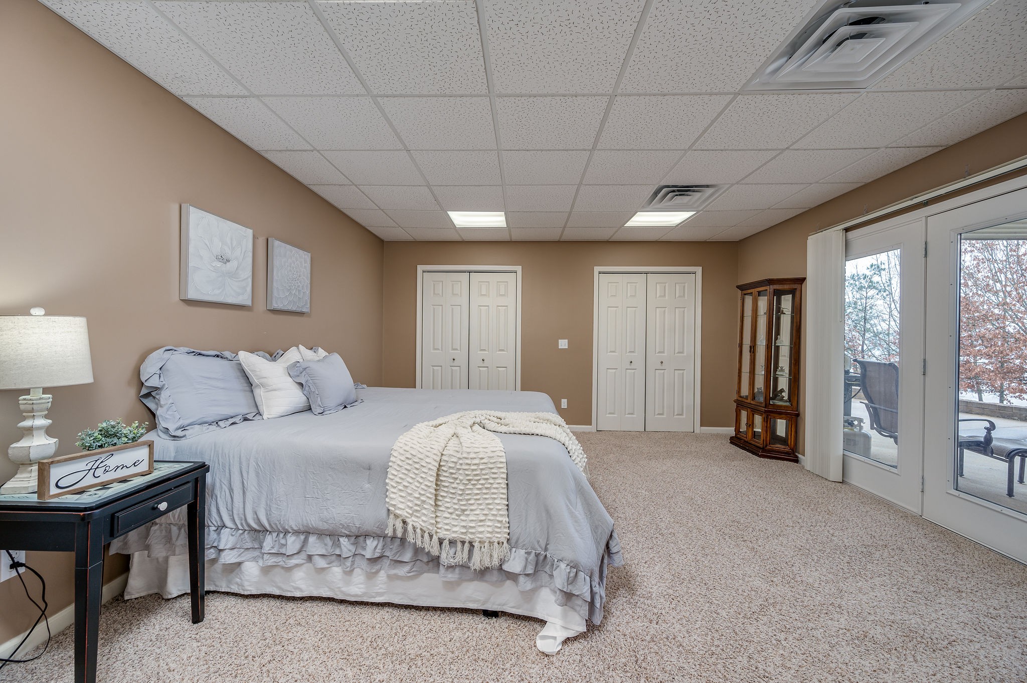 60 Lakeside Estates Road Springville, TN 38256 - Photo 30 of 49 a spacious bedroom with a bed and a chandelier