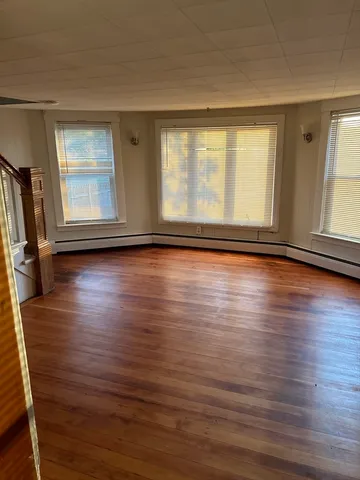 a view of room with hardwood floor and window