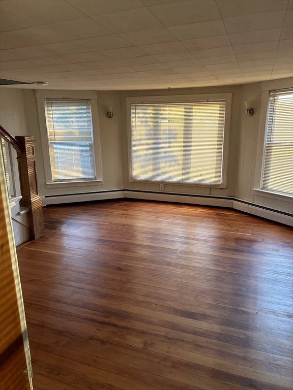 a view of room with hardwood floor and window