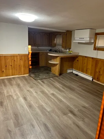 a kitchen with stainless steel appliances granite countertop a sink a stove and a refrigerator