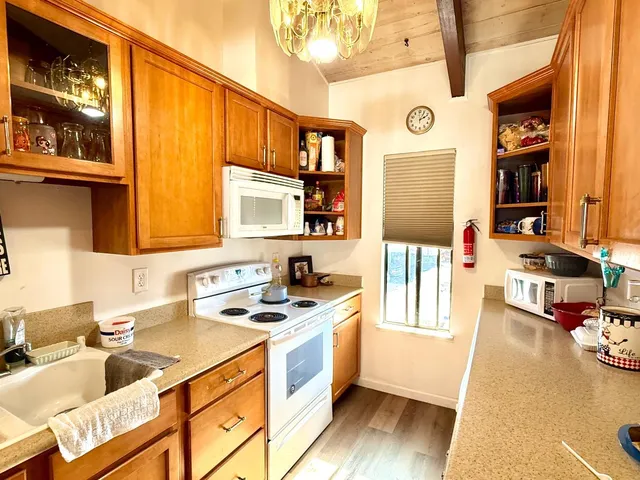 a kitchen that has a sink and a stove in it