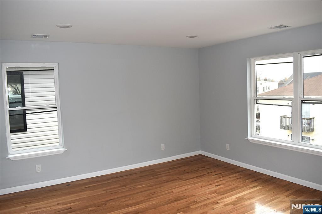593 South 18th Street Newark, NJ 07103 - Photo 15 of 16 wooden floor in an empty room with a window