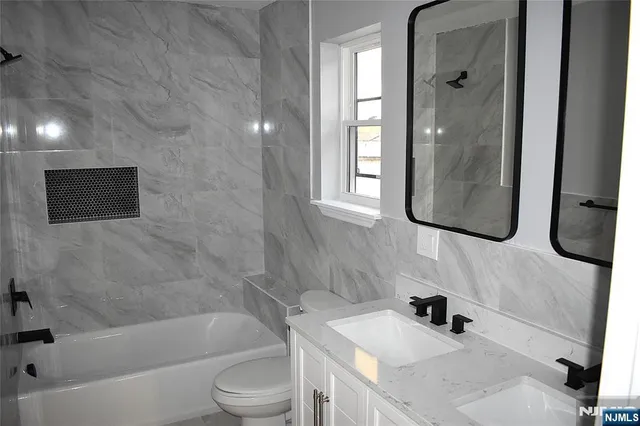 a bathroom with a sink a toilet and bathtub