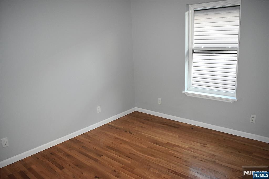 593 South 18th Street Newark, NJ 07103 - Photo 9 of 16 wooden floor in an empty room with a window