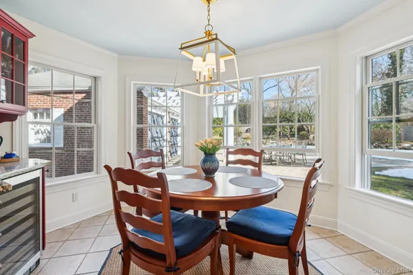 a dining room with furniture a chandelier and wooden floor