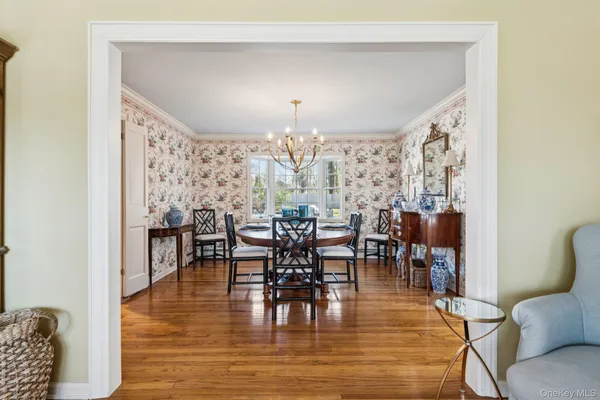 a view of a dining room with furniture and chandelier