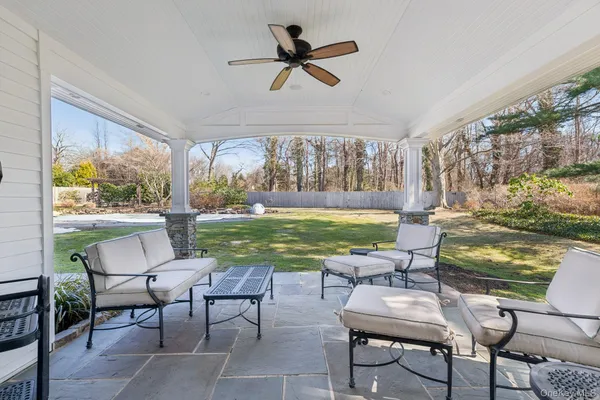 a view of a swimming pool and chairs in patio