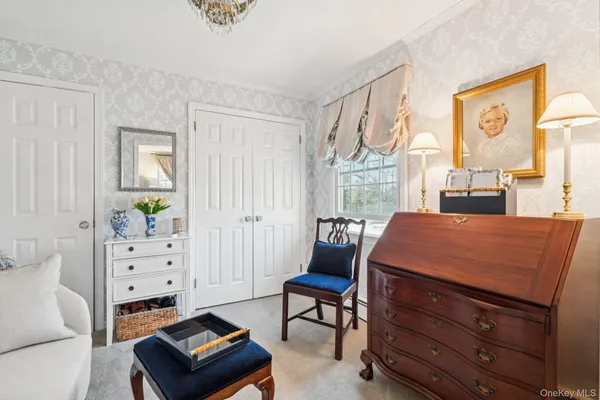 a bedroom with furniture and a window