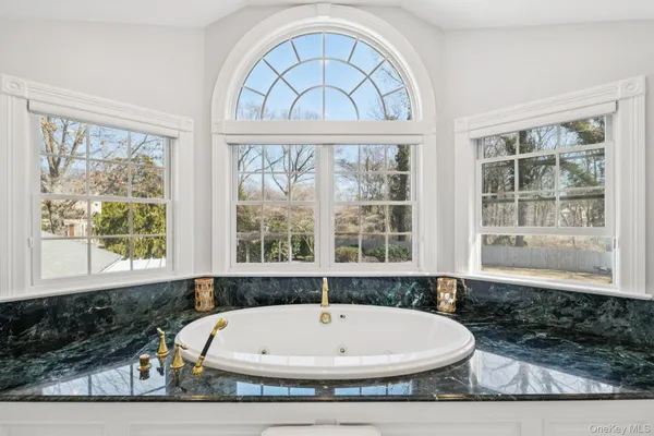 a white bath tub sitting next to a window