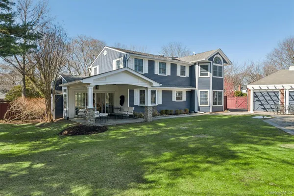a front view of a house with a garden and porch