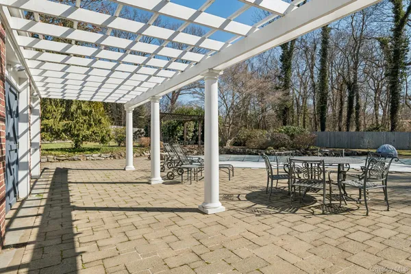 a view of a porch with chairs and backyard