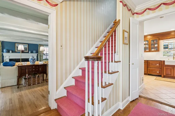 a view of an entryway with wooden floor and windows