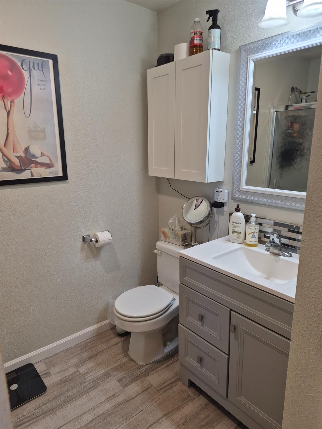 5817 Keyntel Street Citrus Heights, CA 95621 - Photo 13 of 30 a bathroom with a granite countertop toilet sink and mirror