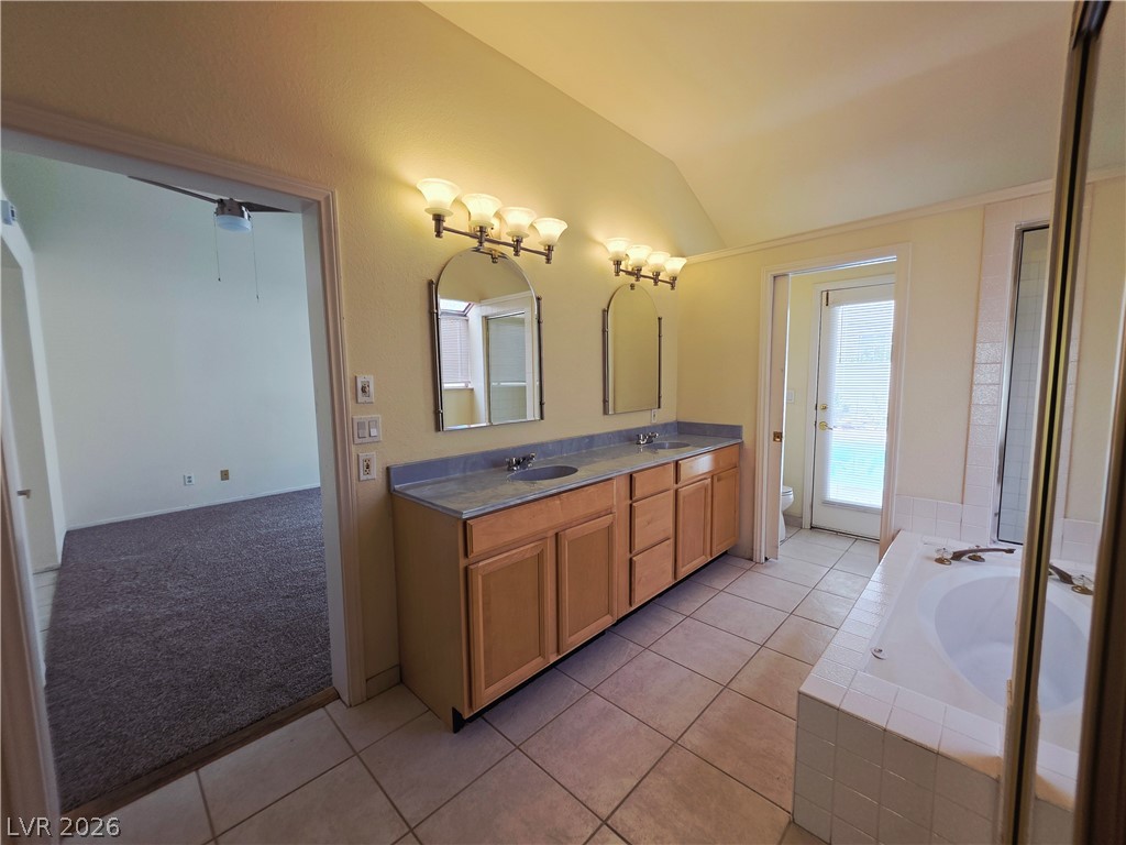 2920 Setting Sun Street Las Vegas, NV 89117 - Photo 28 of 43 This spacious bathroom offers a double vanity and a built-in tub.