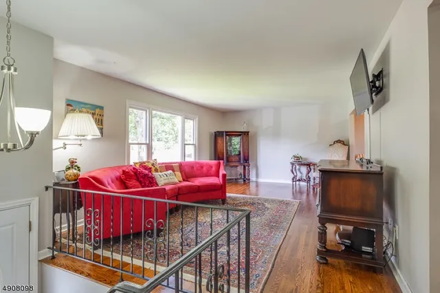a bedroom with furniture and a flat screen tv
