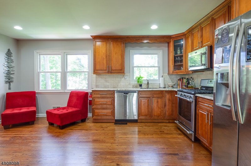 14 Ash Lane Randolph, NJ 07869 - Photo 8 of 22 a kitchen with stainless steel appliances granite countertop a sink a window and wooden floor