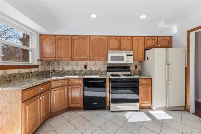 a kitchen with a refrigerator sink and cabinets