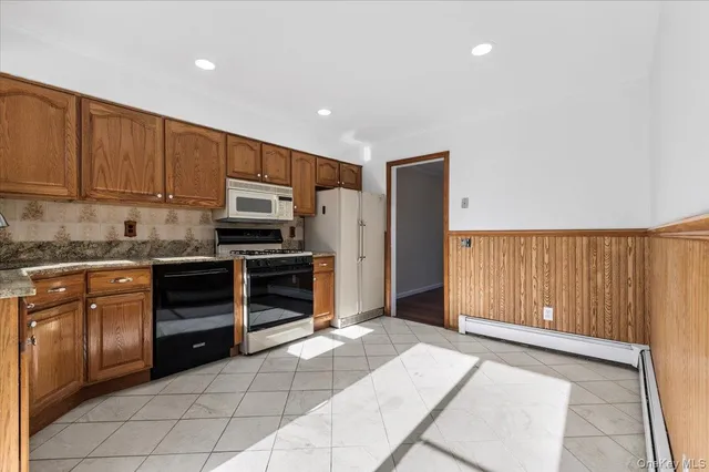 a kitchen with stainless steel appliances a stove sink and cabinets