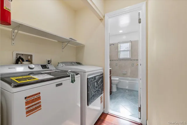 a utility room with sink dryer and washer