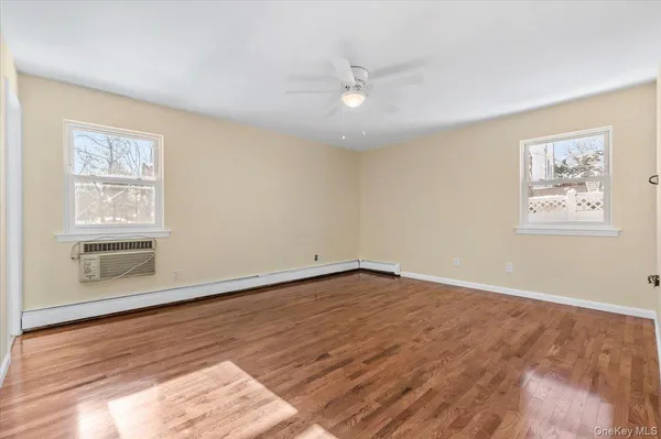 wooden floor in an empty room with a window