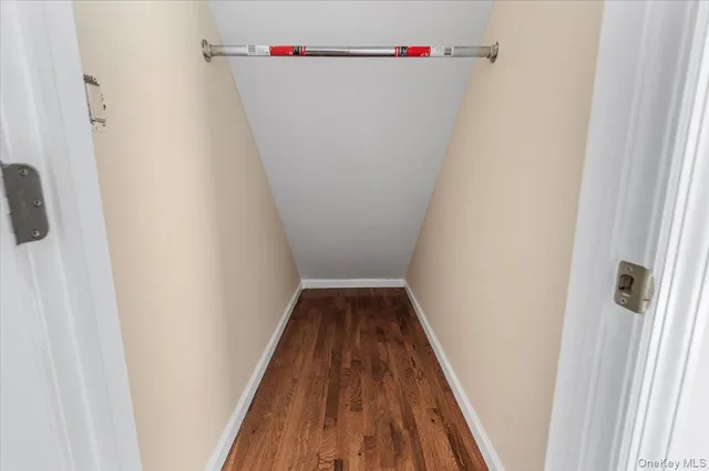 a view of a hallway with wooden floor and entryway