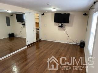 20 Ramsey Road Middlesex, NJ 08846 - Photo 16 of 33 a view of a livingroom with wooden floor and a flat screen tv