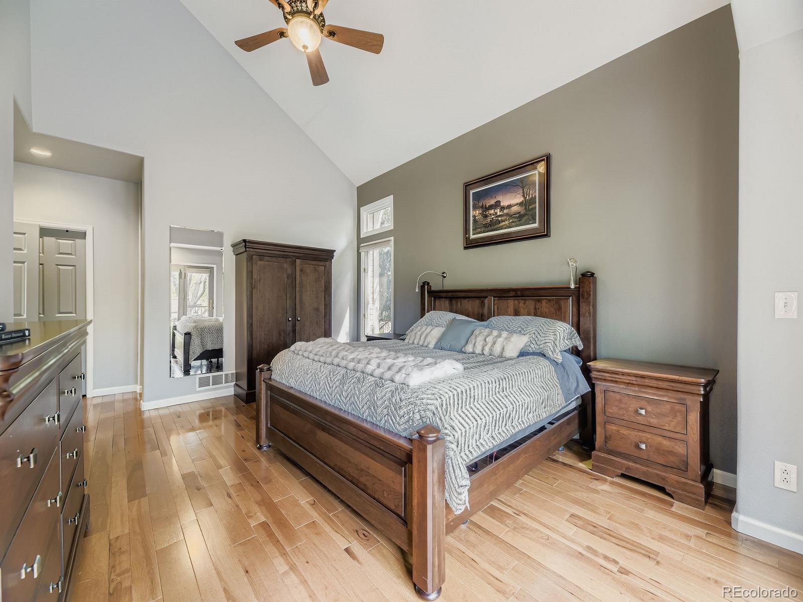 15906 Double Eagle Drive Morrison, CO 80465 - Photo 13 of 34 a bedroom with a bed and a chandelier
