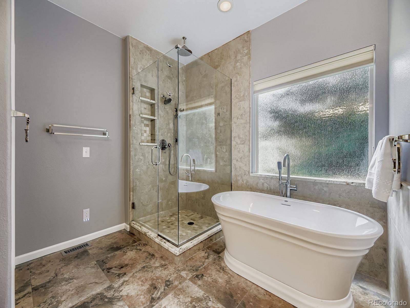15906 Double Eagle Drive Morrison, CO 80465 - Photo 16 of 34 a bathroom with a sink toilet and shower