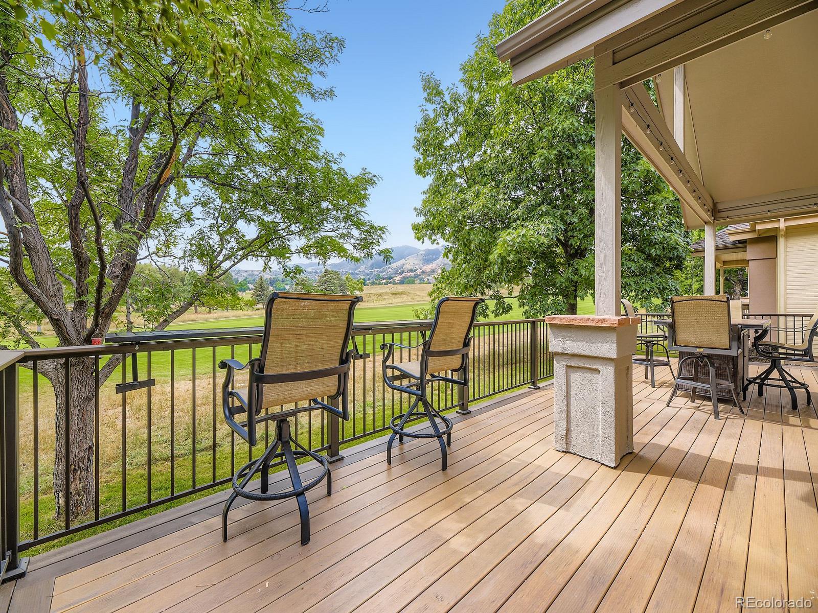 15906 Double Eagle Drive Morrison, CO 80465 - Photo 30 of 34 a view of a chairs and table on the wooden deck