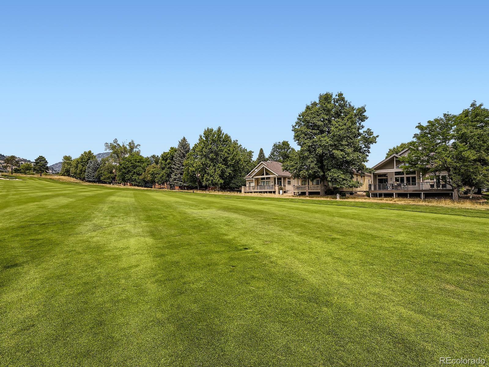 15906 Double Eagle Drive Morrison, CO 80465 - Photo 32 of 34 a view of a green field with plants and trees in the background