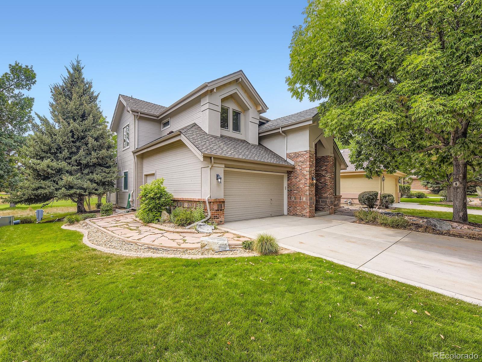 15906 Double Eagle Drive Morrison, CO 80465 - Photo 33 of 34 a front view of a house with a garden and yard