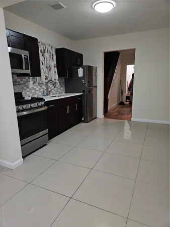 a kitchen with stainless steel appliances granite countertop a stove a refrigerator and a microwave