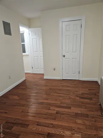 a view of room with window and wooden floor